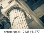 Black and white picture of the details figures sculptures columns of the Acropolis of Athens with amazing and beautiful ruins Parthenon and blue cloudy sky in Greece