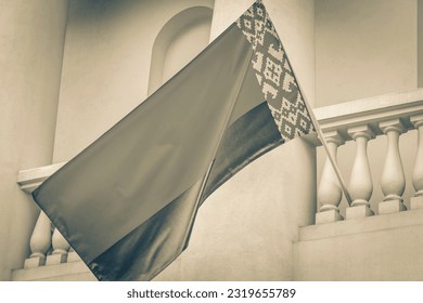 Black and white picture of Flag of Belarus on a building with white background belarusian flag red white green in Minsk Belarus.