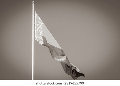 Black and white picture of Flag of Belarus with blue sky and background belarusian flag red white green in Minsk Belarus.