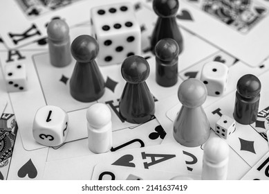 Black and white picture with a lots of board game pieces and solitaire cards. Great for advertisements and backgrounds.