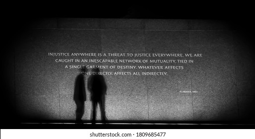 Black And White Picture Of A Reverend Martin Luther King Jr. Memorial Quote In Washington, DC At Night In July 2016 With The Shadows Of Two People.