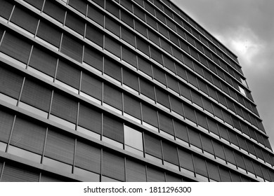 Black and white picture showing a modern facade plenty of glass rectangular windows in Bergen