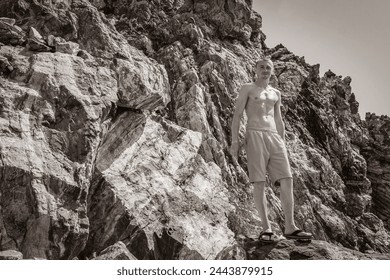 Black and white picture of a young traveler hiker with natural coastal landscapes on Kos Island in Greece with mountains cliffs rocks turquoise blue beaches and waves. - Powered by Shutterstock