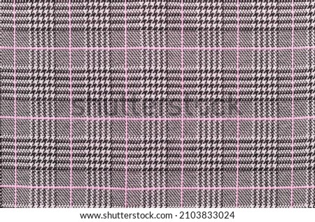 Black, white and pink tartan texture background. houndstooth pattern. Textile and texture concept