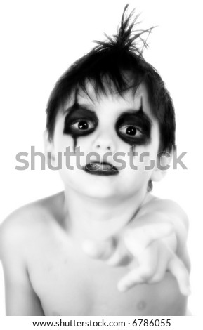 Black and white portrait of adorable little goth boy. Pointing.
