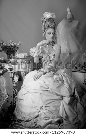 Black and white portrait of a beautiful eighteenth century woman dressed in Rococo fashion