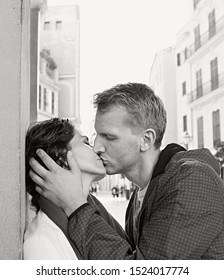 Black And White Portrait Of Beautiful Tourist Couple On Winter City Break Holiday Sightseeing Together, Kissing On Honeymoon Outdoors. Loving Relationship Travel Vacation, Leisure Recreation Lifestyle