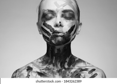 black and white portrait of Beautiful Young woman with Paint on her Face and Body. Girl with halloween make-up