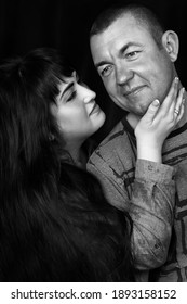 Black And White Portrait Of A Couple In Love In The Studio,when Woman Looks At The Man And Holds His Face With Her Hand,man Looking On The Side And Smilling.