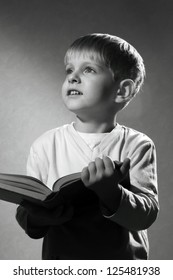  Black And White Portrait Of Cute Little Boy With Book Looking Up