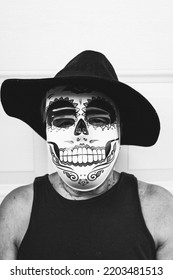 Black And White Portrait Of An Elderly Lady With A Catrina Mask And Hat, Celebrating Halloween And All Souls' Day, On A White Background. Celebration, Costume, Party And Mask Concept.