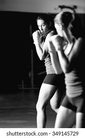 Black And White Portrait Of Female Boxer Fighting And Looking In The Mirror