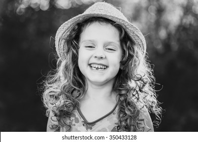 Black And White Portrait Of A Funny Little Girl. Child Missing Tooth. Happy Childhood Concept.