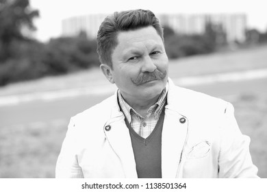 Black And White Portrait Of A Handsome Man With A Mustache Age 55 Years.