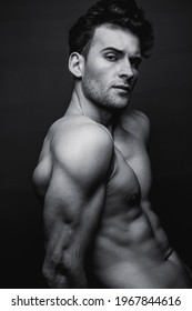 Black And White Portrait Of A Handsome Young Man With A Stylish Haircut.  Studio Shot