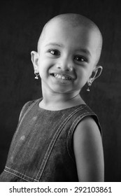 Black And White Portrait Of An Indian Girl Child With Shaved Head