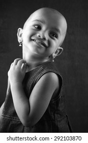 Black And White Portrait Of An Indian Girl Child With Shaved Head