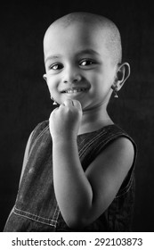 Black And White Portrait Of An Indian Girl Child With Shaved Head