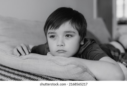 Black And White Portrait Kid  Bored Face Looking Deep In Thought,Lonely Boy With Thinking Face Sitting Alone On Sofa,Upset Preschool Child With Unhappy Or Sad Face,Spoiled Children,Mental Health