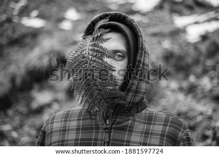 Similar – ein Mädchen mit langen Haaren und blauen Augen in den Bergen, das mit einer Kapuze lächelt