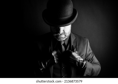 Black and White Portrait of Mean Man in Dark Suit and Bowler Hat. Concept of Film Noir Gangster Villain. Violent Backstreet Brute.