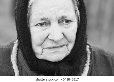 Black and white portrait of old lonly woman in headscarf