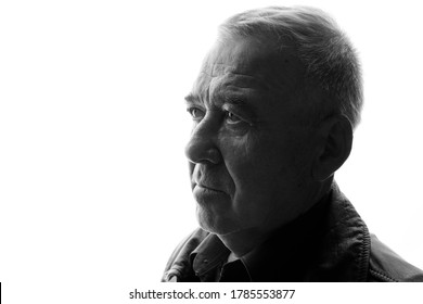 Black And White Portrait Of Old Man On White Background. Aged Male In Profile. Free Space For Text.