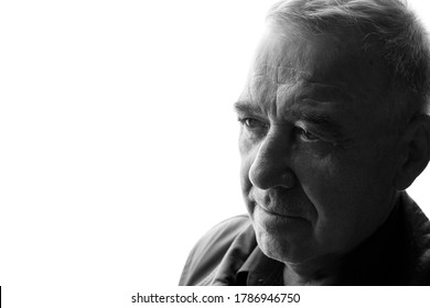 Black And White Portrait Of Old Man On White Background. Aged Male In Profile. Free Space For Text.