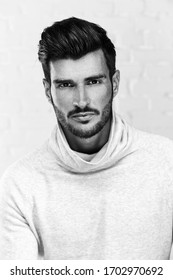 Black And White Portrait Photo Of Cool Handsome Young Man Looking At Camera, White Background.