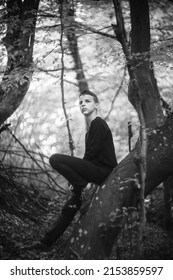 Black And White Portrait Of A Sad Boy Outside In Nature