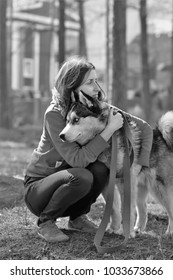 Black And White Portrait Of A Sad Woman Saying Goodbye To Her Husky Sled Dog Pet