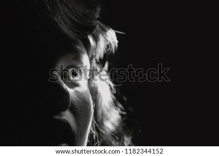 Black and white portrait  of a scared woman