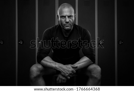 Black and white portrait of a sports man in the locker room