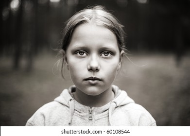 Black and white portrait of tired little girl with sad eyes. Shallow DOF - Powered by Shutterstock