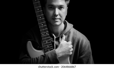 Black And White Portrait Of Young Asian Handsome Guitarist, Artist, Composer, Pop Rocker Star. Music Concept