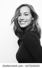 Black And White Portrait Of A Young Happy Woman Or Adult With A Big Smile On Her Face, Having Beautiful Teeth And Looking Fashionable And Attractive, Concept Bland And White