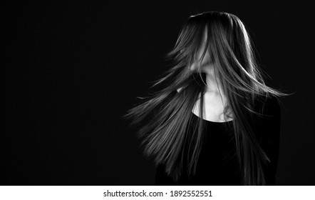 Black and white portrait of young happy brunette woman with luxurious long hair shaking her head to make her hair flying in the wind after hair restoring spa procedures. Hairstyle. Hair cosmetics - Powered by Shutterstock