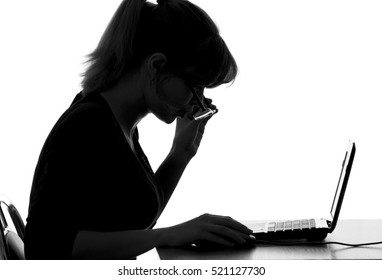 black and white portrait of a young woman wearing glasses surprised by the information seen on the Internet with a computer at home