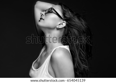 Similar – Young woman in black lingerie in chiaroscuro lighting