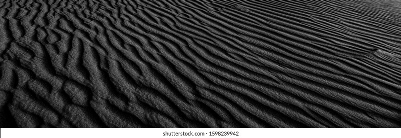 Black and white poster texture sand in the desert. Panaroma Sand texture. abstract texture line wave. Sand Waves Abstract Black and White background. Volcanic rock texture. Black salt. Black Sand. - Powered by Shutterstock