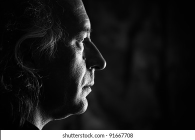 Black And White Profile Portrait Of Older White Male With Side Lighting.