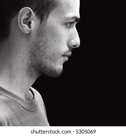 Black And White Profile Portrait Of A Young Man - Isolated Over Black