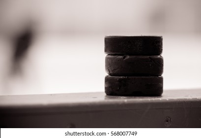 Black And White Puck On The Board In Hockey Arena