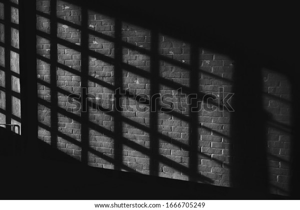 Black white quadratic shadow on a stonework wall\
illuminated by late sunlight - concept dramatic contrast film noir\
mystic interior texture background surface structure window close\
up detail evening