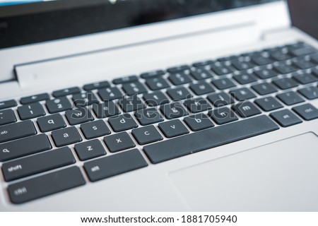 Black and white qwerty keyboard on modern laptop computer