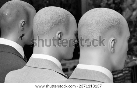 black and white rear view of male mannequins
