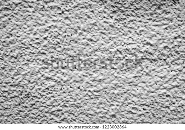 black
and white relief wall of the house. Dirty shabby wall with putty.
Relief paint black and white. The wall paint is like clouds and
sky. View of the mountains and craters of the
moon.