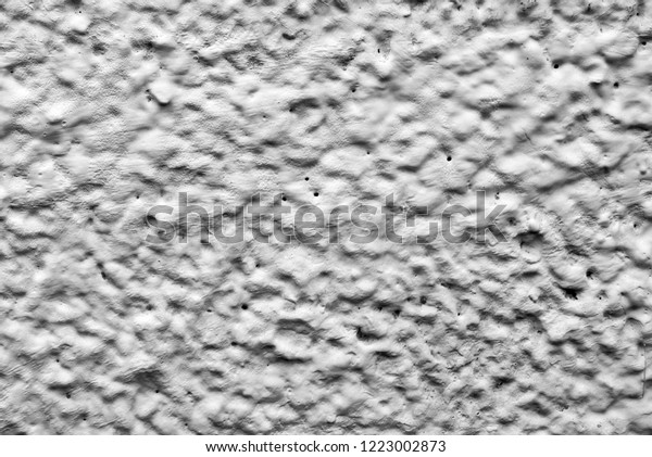 black\
and white relief wall of the house. Dirty shabby wall with putty.\
Relief paint black and white. The wall paint is like clouds and\
sky. View of the mountains and craters of the\
moon.
