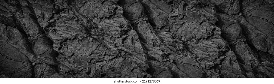 Black white rock texture background  Rough mountain surface and cracks  Close  up  Dark gray stone basalt background for design  Banner  Wide  Long  Panoramic  Website header 