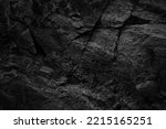 Black white rock texture with cracks. Rough surface mountain surface. Close-up. Dark grey. Stone granite background with space for design. Grunge. Broken.